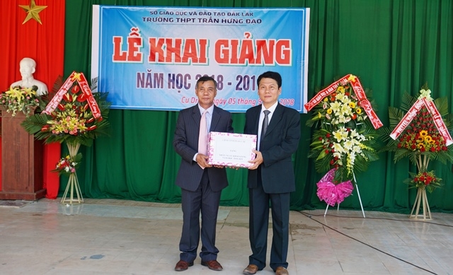 Chủ tịch Uỷ ban MTTQ Việt Nam tỉnh Y Dec Hđơk tặng quà của UBND tỉnh cho Trường THPT Trần Hưng Đạo.
