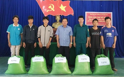 Anh Hoàng Văn Đề (thứ ba từ phải sang) trao tặng gạo cho hộ nghèo từ nguồn Quỹ Hũ gạo nuôi quân.