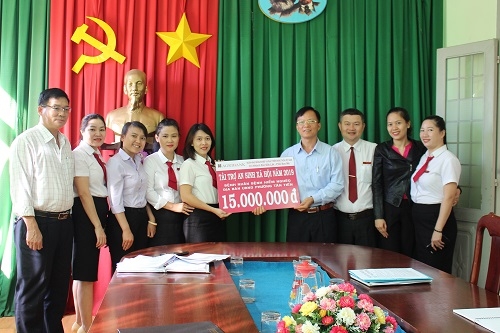 Đại diện Ngân hàng Agribank chi nhánh Bắc Đắk Lắk - PGD Ban Mê trao số tiền tượng trưng cho lãnh đạo phường Tân Tiến