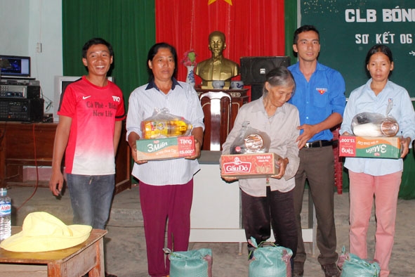Anh Đỗ  Hữu Phong (thứ hai từ phải sang) thay mặt  CLB bóng đá Newlife  tặng quà  cho các hộ  có  hoàn cảnh  khó khăn. 