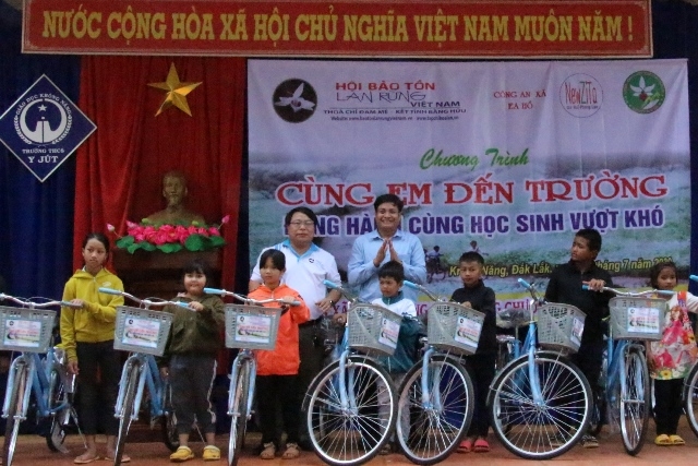 Các em học sinh nghèo vượt khó trên địa bàn xã Ea Hồ nhận xe đạp tại Chương trình