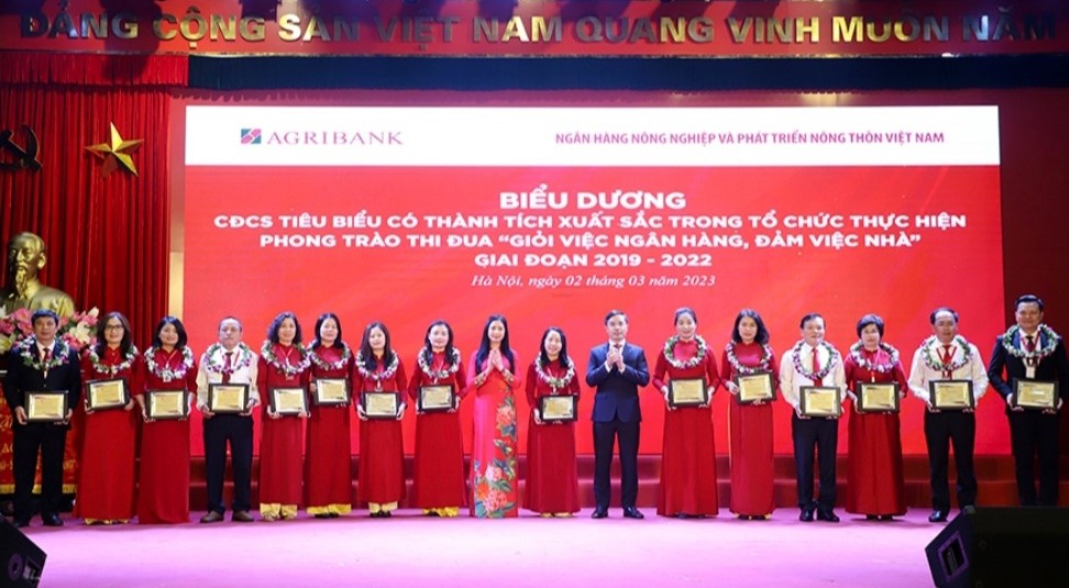 Ông Phan Thông Thái (bìa trái), Phó Giám đốc, Chủ tịch Công đoàn cơ sở Agribank Đắk Lắk nhận vinh danh Công đoàn cơ sở tiêu biểu có thành tích xuất sắc trong tổ chức thực hiện Phong trào thi đua “Giỏi việc ngân hàng, đảm việc nhà” giai đoạn 2019 -2022. 