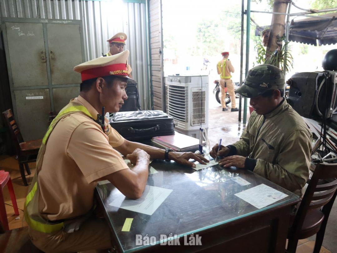 Cán bộ Phòng Cảnh sát giao thông (Công an tỉnh) lập biên bản xử lý vi phạm hành chính đối với người vi phạm giao thông.