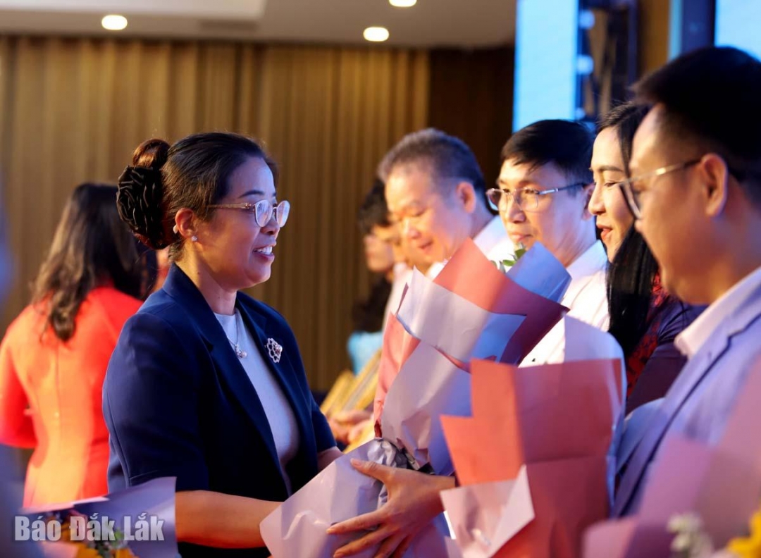 Phó Bí thư Tỉnh ủy Huỳnh Thị Chiến Hòa trao bằng khen, hoa cho các tập thể xuất sắc. Ảnh: Trung Hiếu 