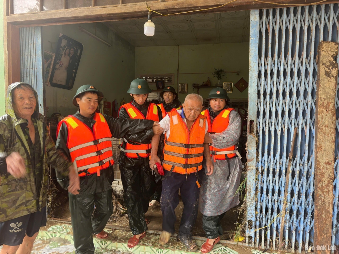 Các chiến sĩ hỗ trợ đưa người già đến nơi an toàn.
