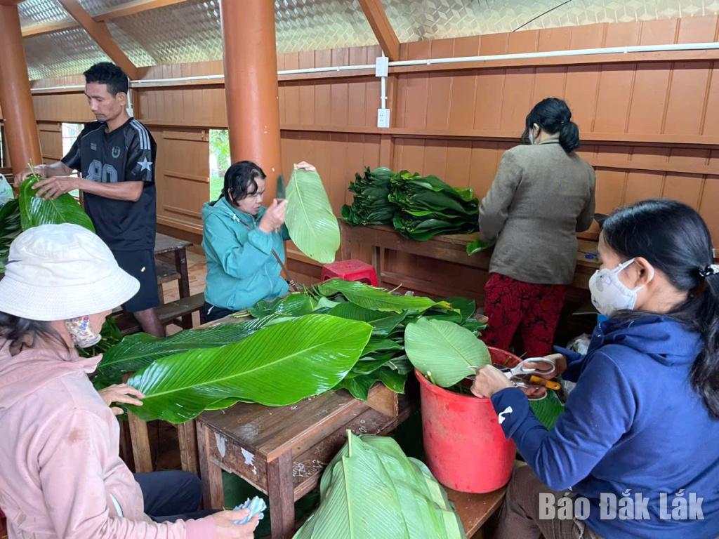 Người dân tộc thiểu số buôn Ea Nao A tập trung gói bánh chưng, bánh tét tại Nhà sinh hoạt văn hóa cộng đồng buôn.