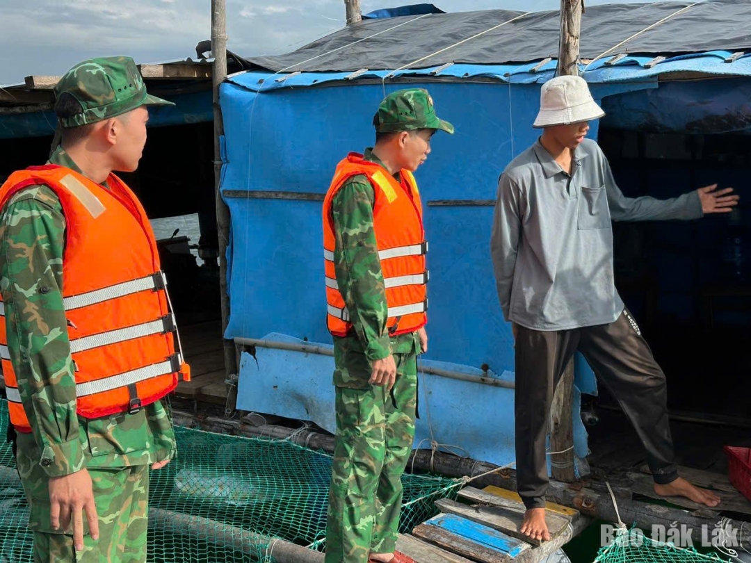 Cán bộ, chiến sĩ Đồn Biên phòng Xuân Hoà tuyên truyền thông tin bão số 13 cho các chủ phương tiện, chủ lồng bè trên địa bàn. Ảnh: Đăng Vũ