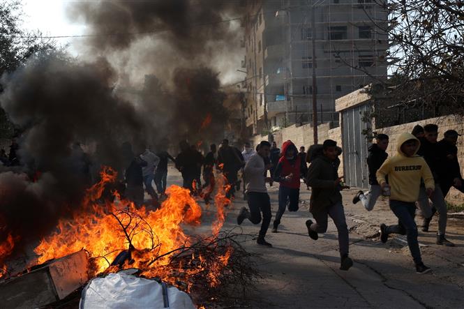 Người Palestine trong cuộc đụng độ với các lực lượng Israel tại Jenin, Bờ Tây ngày 26/1. Ảnh: THX/TTXVN