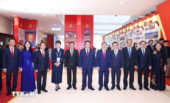 Politburo member and Permanent member of the Party Central Committee’s Secretariat Tran Cam Tu (fifth, left), and officials at the opening ceremony of the exhibition “Under the Party leadership, the nation enters a new era” organised by the Vietnam News Agency on January 14. Photo: VNA