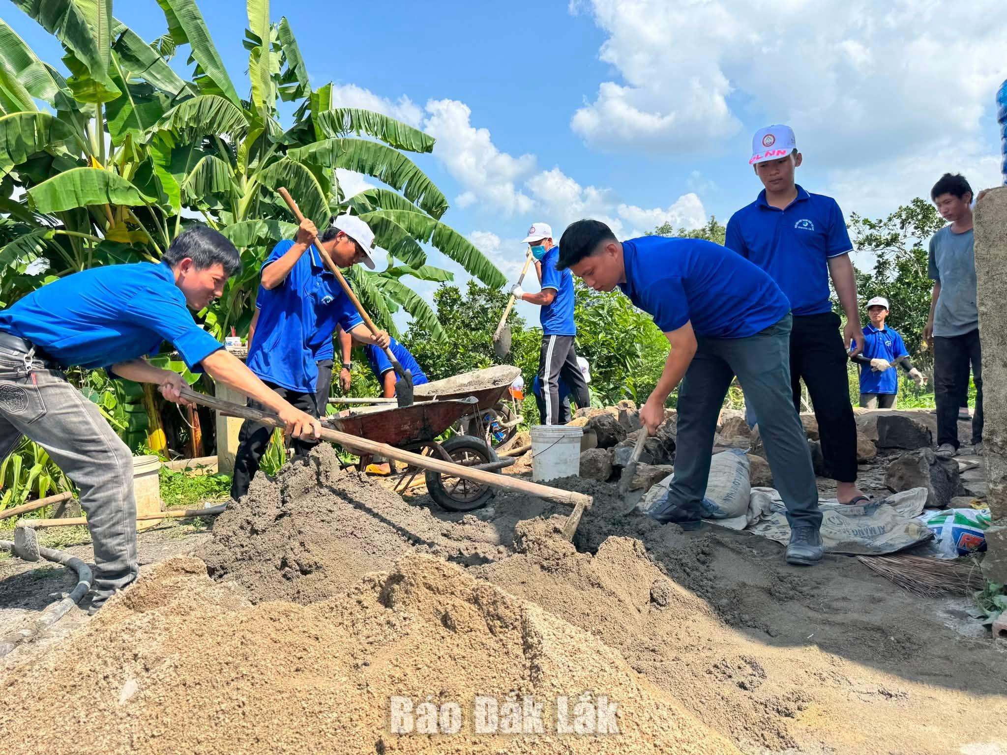 Thanh niên tình nguyện tham gia tu sửa nhà cho gia đình có công với cách mạng ở xã Ea Wer.