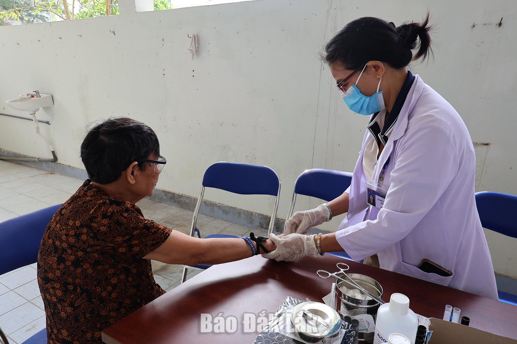 Cán bộ Trung tâm Y tế Đông Hòa kiểm tra các chỉ số sức khỏe cơ bản cho người dân.