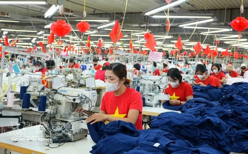 A favourable business environment will enable companies to step up investment, production and business activities. (Photo: VNA)