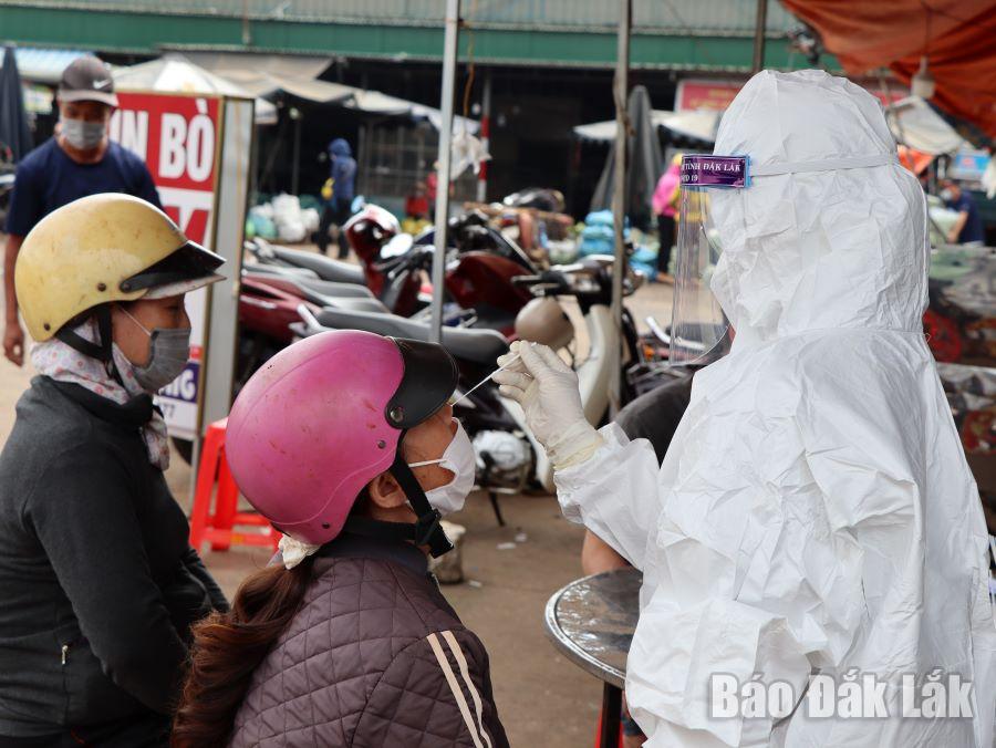 Lực lượng y tế lấy mẫu xét nghiệm SARS-CoV-2 cho người dân tại chợ đầu mối Tân Hòa, phường Tân Hòa (TP. Buôn Ma Thuột).