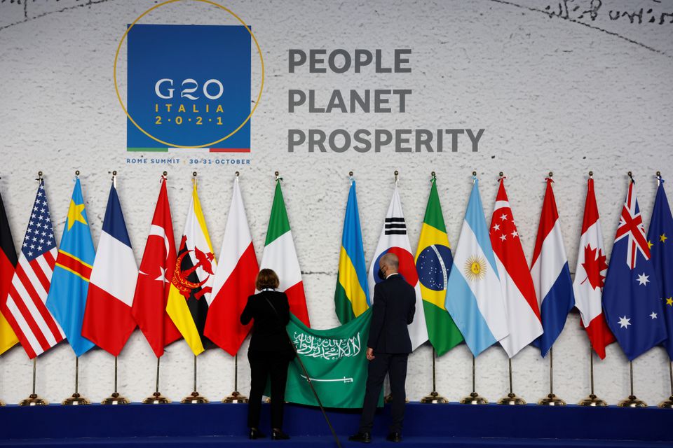Nhân viên treo quốc kỳ Saudi Arabia trong quá trình chuẩn bị trước cuộc hội nghị thượng đỉnh các nhà lãnh đạo G20 tại trung tâm hội nghị La Nuvola, ở Rome, ngày 30/10/2021. (Ảnh: Reuters/TTXVN)