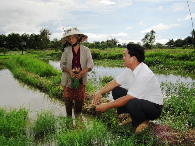 Anh Khánh trao đổi kỹ thuật sản xuất lúa giống xác nhận với nông dân thôn 6, xã Ea Lê).