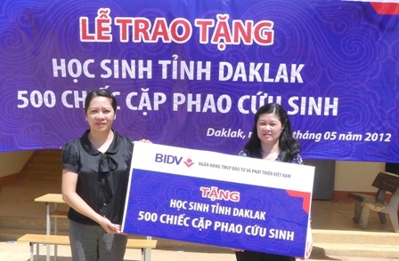 Đại diện Ngân hàng Đầu tư Phát triển Việt Nam trao biểu trưng 500 cặp phao cứu sinh cho Phó Chủ tịch LĐLĐ tỉnh Võ Thị Hạnh