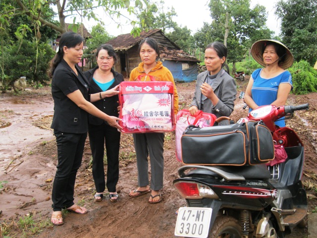 Chính quyền địa phương và các đoàn thể tặng quà cho gia đình nạn nhân của cơn lũ tại thị trấn Ea Drăng.