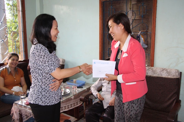 Đại diện Hội Liên hiệp Phụ nữ tỉnh (bên trái) trao quà tặng gia đình chị Phan Thị Lan.