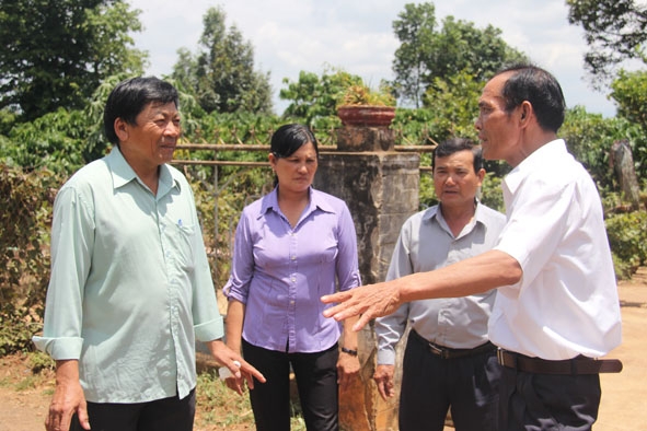 Đồng chí Phạm Công Thành, Bí thư Đảng ủy xã Ea Hu (bìa trái) đang trao đổi với bà con nông dân.