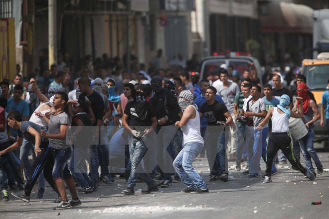 Người Palestine trong cuộc xung đột với cảnh sát Israel tại thành phố Ramallah, Bờ Tây ngày 6-10. (Nguồn: THX/TTXVN)