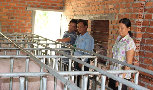 Anh Hoàng Nhật Huy (ngoài cùng bên trái) chia sẻ kinh nghiệm  chăn nuôi với các thành viên trong tổ chăn nuôi heo của thôn 7A.