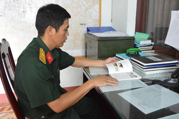 Thiếu tá Lê Minh Ngọc đang nghiên cứu  tài liệu về binh khí, kỹ thuật.