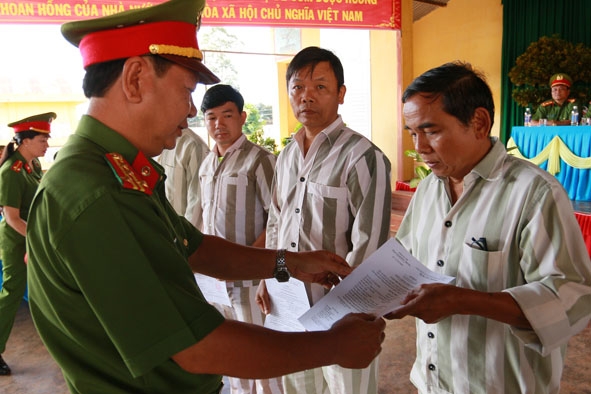 Đại tá Đặng Duy Văn, Giám thị Trại giam Đắk Trung trao giấy chứng nhận đặc xá cho các phạm nhân.