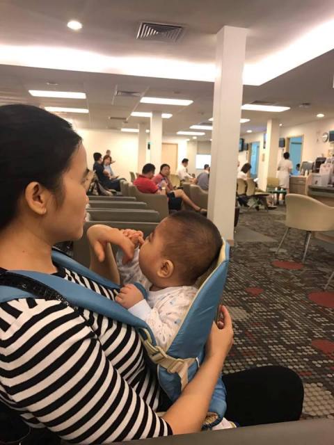 Hai mẹ con cháu Tuệ Minh đang chờ khám tại Bệnh viện Mắt Singapore.