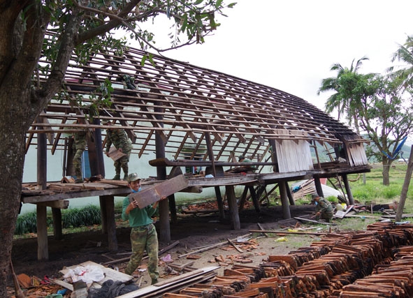 Cán bộ, chiến sĩ lực lượng vũ trang tỉnh giúp nhân dân xã Yang Mao sửa chữa lại nhà cửa.  