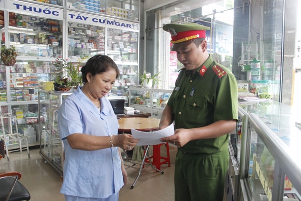 Công an Thị trấn Quảng Phú phát tờ thông báo, hướng dẫn người dân cùng phối hợp  tham gia phòng chống tội phạm.
