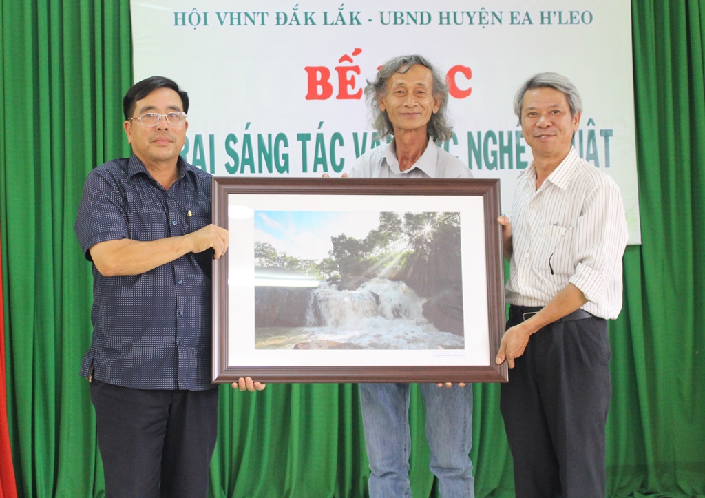Chủ tịch Hội VHNT tỉnh Lê Khôi Nguyên và tác giả Văn Lộc trao tác phẩm 