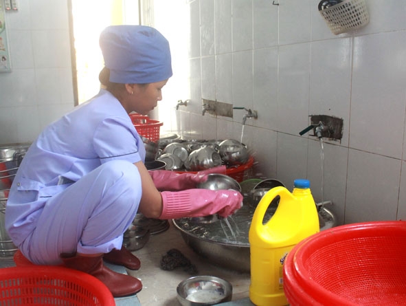 Nhân viên nhà bếp của Trường Mầm non Hòa Khánh vệ sinh dụng cụ sau bữa ăn của học sinh.