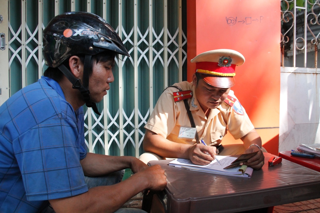 Lực lượng CSGT (Công an TP. Buôn Ma Thuột) lập biên bản xử phạt hành chính người vi phạm giao thông.
