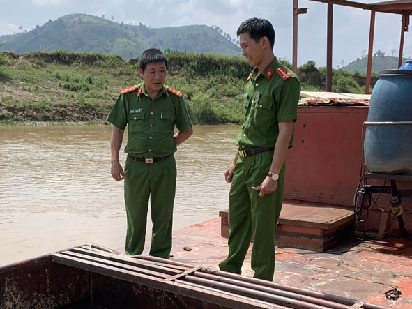 Đại tá Lê Văn Sơn (bên trái) trong một lần cùng đồng đội xử lý vụ việc khai thác cát  trái phép. 