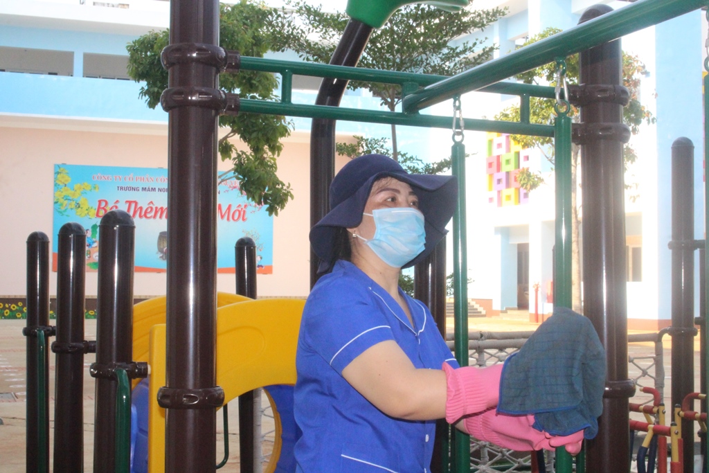 Nhân viên Trường Mầm non Hoa Việt Nguyên (TP. Buôn Ma Thuột) vệ sinh khu vui chơi chuẩn bị đón trẻ trở lại trường học.