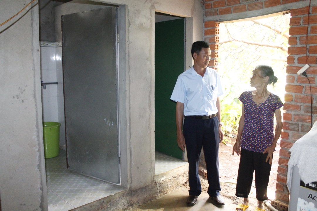 Cán bộ xã Ea Kpam (huyện Cư M'gar) kiểm tra công trình nhà tiêu của hộ bà Lê Thị Hiền sau khi được hỗ trợ xây dựng.