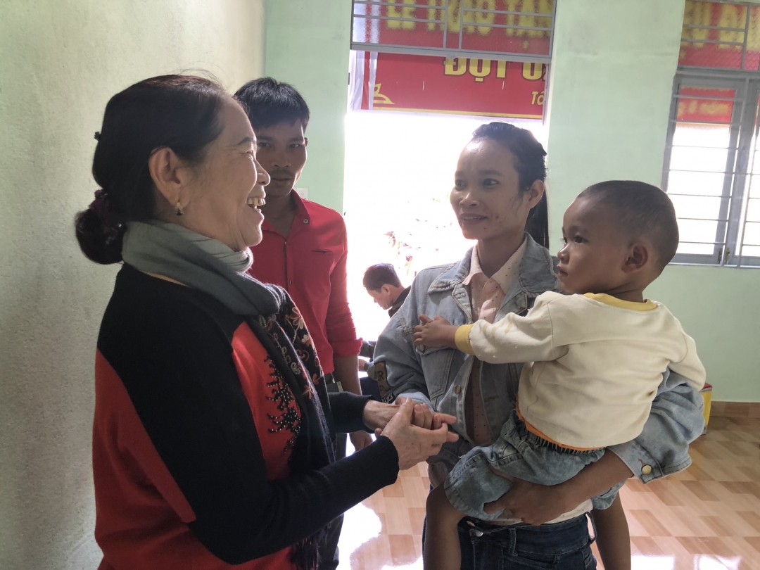 Bà Nguyễn Thị Vân, Chủ tịch Hội Bảo trợ người tàn tật và trẻ mồ côi tỉnh (bên trái) thăm hỏi gia đình chị H’Juê Niê trong căn nhà mới.